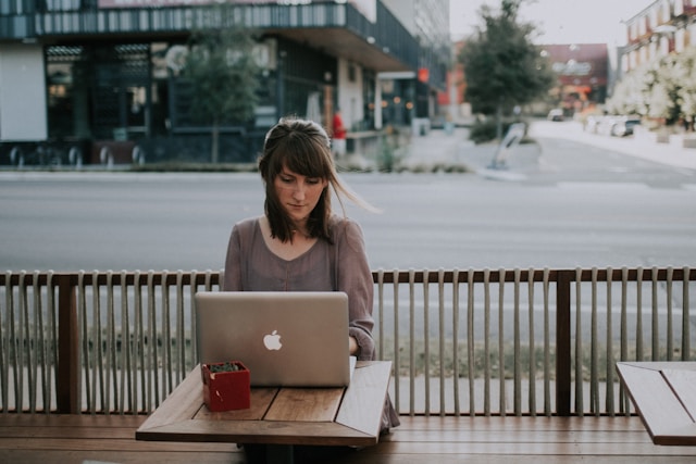 girl is typing on a laptop