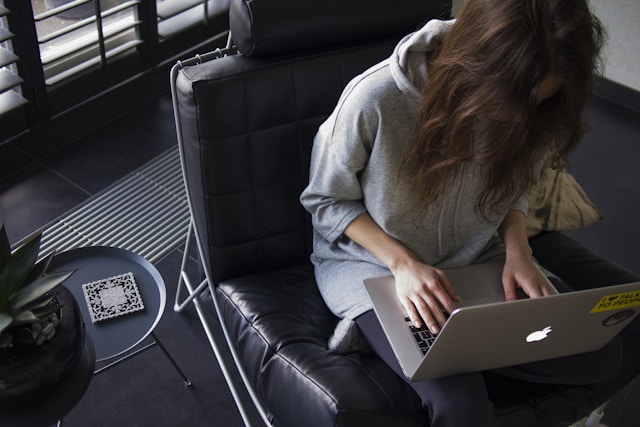 girl is typing on a laptop