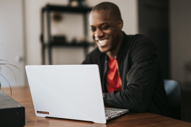 man is typing on a laptop